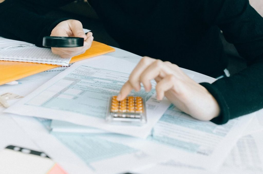 Personne faisant des calculs et se rendant compte de la rentabilité d'avoir fait appel à la conciergerie La Maison Clé